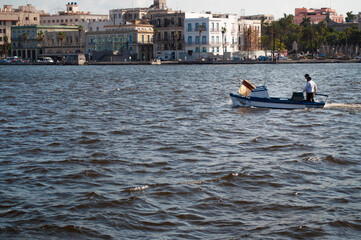 Fishermen sailing their boat inside the bay of havana