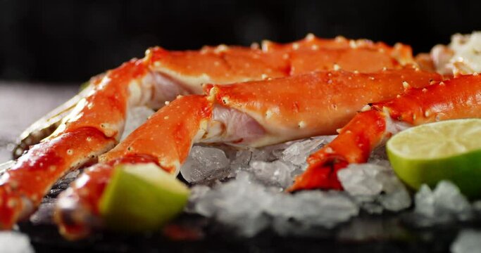 Boiled crab on ice with pieces of lime rotates. 