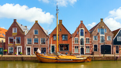Monnickendam centre with a frontal view of tradional dutch houses and a frisian skutsje (dutch...