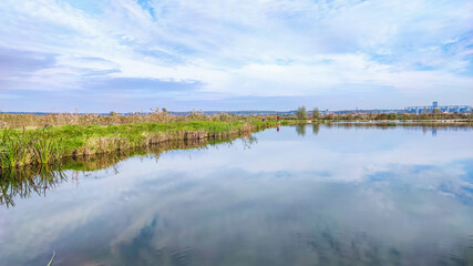 Obraz premium Sunny day on the perfect lake. Autumn lake with reflection on the water. Cloudy sky in the sunny day.