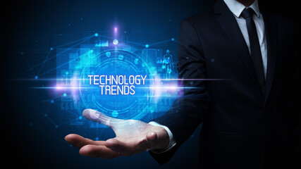 Man hand holding TECHNOLOGY TRENDS inscription, technology concept