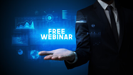 Hand of Businessman holding FREE WEBINAR inscription, business success concept