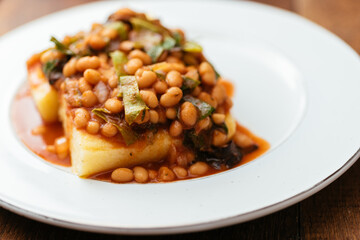 Swiss chard and beans served on polenta