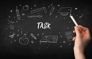 Hand drawing TASK inscription with white chalk on blackboard, education concept