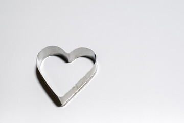 Various Christmas-themed cookie cutters. Xmas cookie cutters on white.