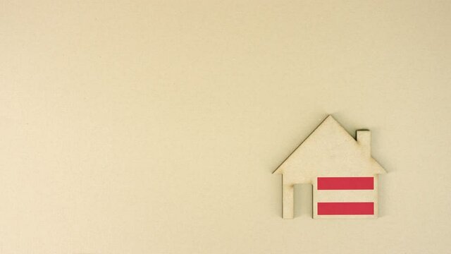 Cardboard house icon with flag of Austria, real estate market concept