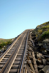 Obraz premium Cog railway track disappearing into the distance over the top of Mount Washington