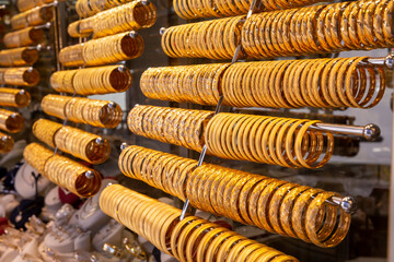 close up Gold bracelets lined up side by side