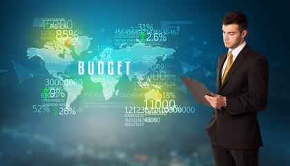 Businessman in front of a decision with BUDGET inscription, business concept