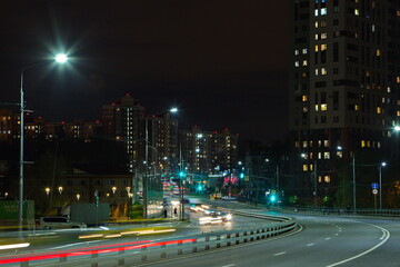 Fototapeta premium The streets of the night city in the lights of passing cars.