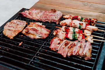 Selective focus. Skewer of chicken with pieces of red and green peppers, pork rib in a barbecue. Food. Life Style.