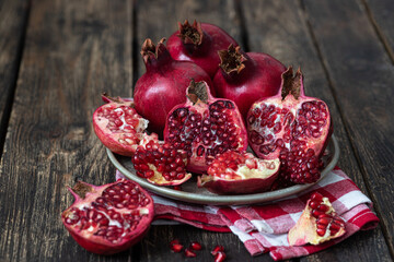Obraz na płótnie Canvas Fresh juicy pomegranate - whole and cut