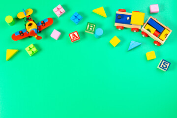 Set of colorful children toys on light green background. Top view, flat lay
