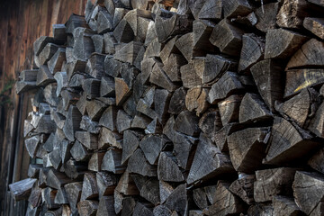 A pile of firewood piled up outside the house