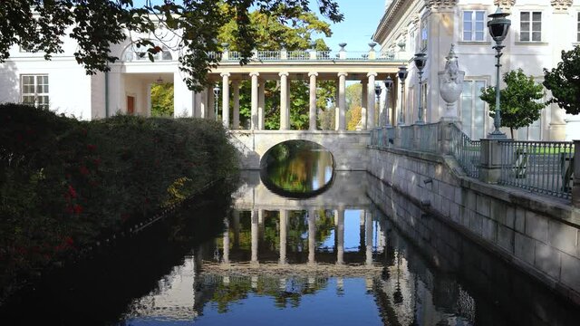 4k footage of bridge leading to Palace on the Isle also called Palace on the Water in Lazienki Krolweskie, Royal Baths Park in Warsaw, Poland