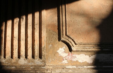 texture of old wall and decorative decoration in the rays of the sun