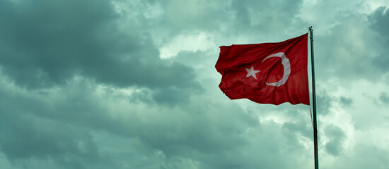 Turkish flag on cloudy sky background
