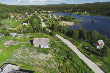 Fototapeta na wymiar Aerial Townscape of Suburban Village Kolvica located in Northwestern Russia on the Kola Peninsula Kandalaksha Area