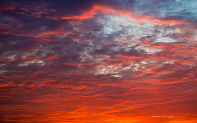 Naklejka na ściany i meble Orange clouds in the sunset sky