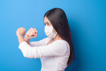 portrait of young woman is wearing face mask on Blue background