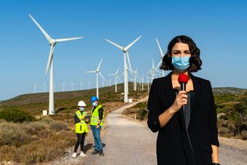 Journalist conducting interview of renewable energy in wind turbine. Journalism industry, live...