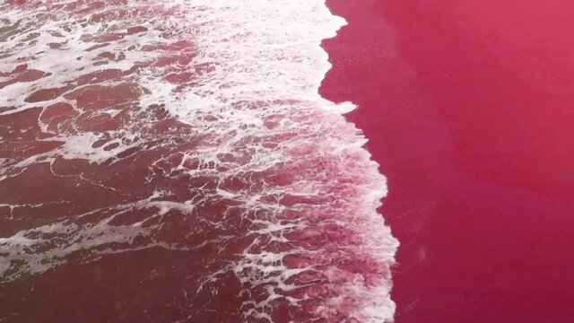 Aerial view of beautiful green sea water surface & white ocean foam wave crashing exotic pink sandy coast & seashore in tropical summer sunset sunlight at Natai Beach Phang Nga, B-roll Slow Motion 