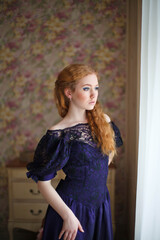 beautiful red-haired girl in vintage dress