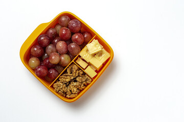 Food in Plastic containers ready to eat with Cheese, grapes and nuts