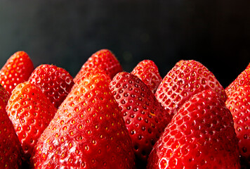 41 - Joint of fresh strawberries without leaves on a black background
