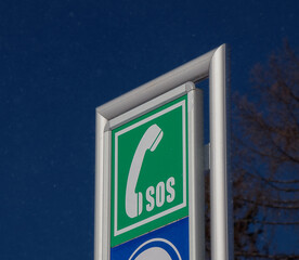 Green emergency call sign SOS on the pillar square