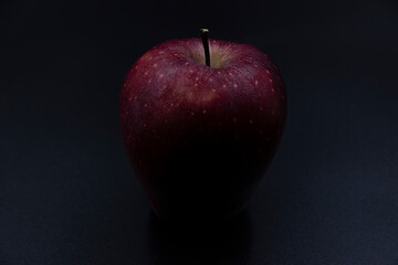 100 - The fruit of a whole apple in a dark background