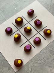Children's game TIC TAC toe made of chestnuts and plasticine