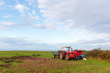 old tractors stopped after a day's work in the field. agriculture and rural life concept.
