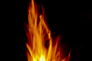 Bright golden orange flames against black background with copy space