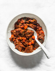 Ingredients for cooking beef in burgundy - beef fillet, tomato sauce, red wine, vegetables on a light background, top view