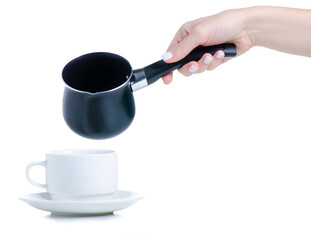 Black cezve coffee turk with cup and saucer on white background isolation