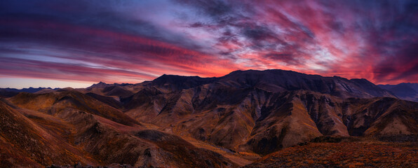 Panoramic View of Scenic Landscape and Mountains in Canadian Nature. Dramatic Colorful Twilight Sky Artistic Render. Aerial Shot. Taken in Tombstone Territorial Park, Yukon, Canada.