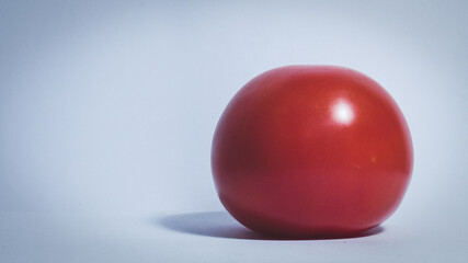 Red ripe tomato lies on the table                      