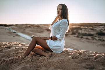 Fototapeta na wymiar moroccan girl in the dunes of the south of spain and beach coast white tarifa bolonia