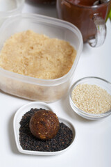 Dried fruit and nut sweets. The ingredients and tools for cooking are spread out on the table. Cooking sweets at home in isolation during an epidemic.