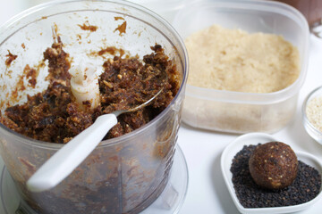 Dried fruit and nut sweets. The ingredients and tools for cooking are spread out on the table....