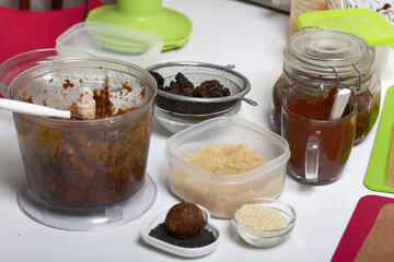 Dried fruit and nut sweets. The ingredients and tools for cooking are spread out on the table. Cooking sweets at home in isolation during an epidemic.