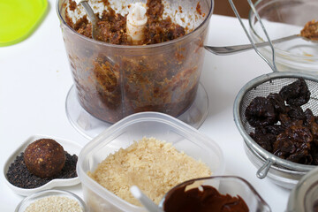 Dried fruit and nut sweets. The ingredients and tools for cooking are spread out on the table. Cooking sweets at home in isolation during an epidemic.