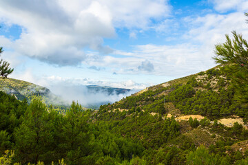 Confrides mountain&acute;s port in the morning one day with low fog and clouds.
