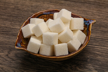 Refined white sugar cubs in the bowl