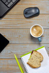 Working and eating lunch at home office on a laptop computer