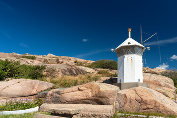 View of lighthouse on rock against sky