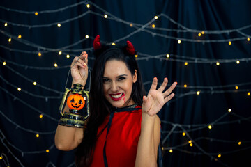 Caucasian woman wearing witch costume in Halloween festival party with black background and light