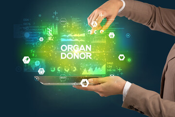 Obraz premium Close-up of a touchscreen with ORGAN DONOR inscription, medical concept