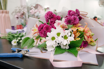 Florist equipment with flowers on wooden background